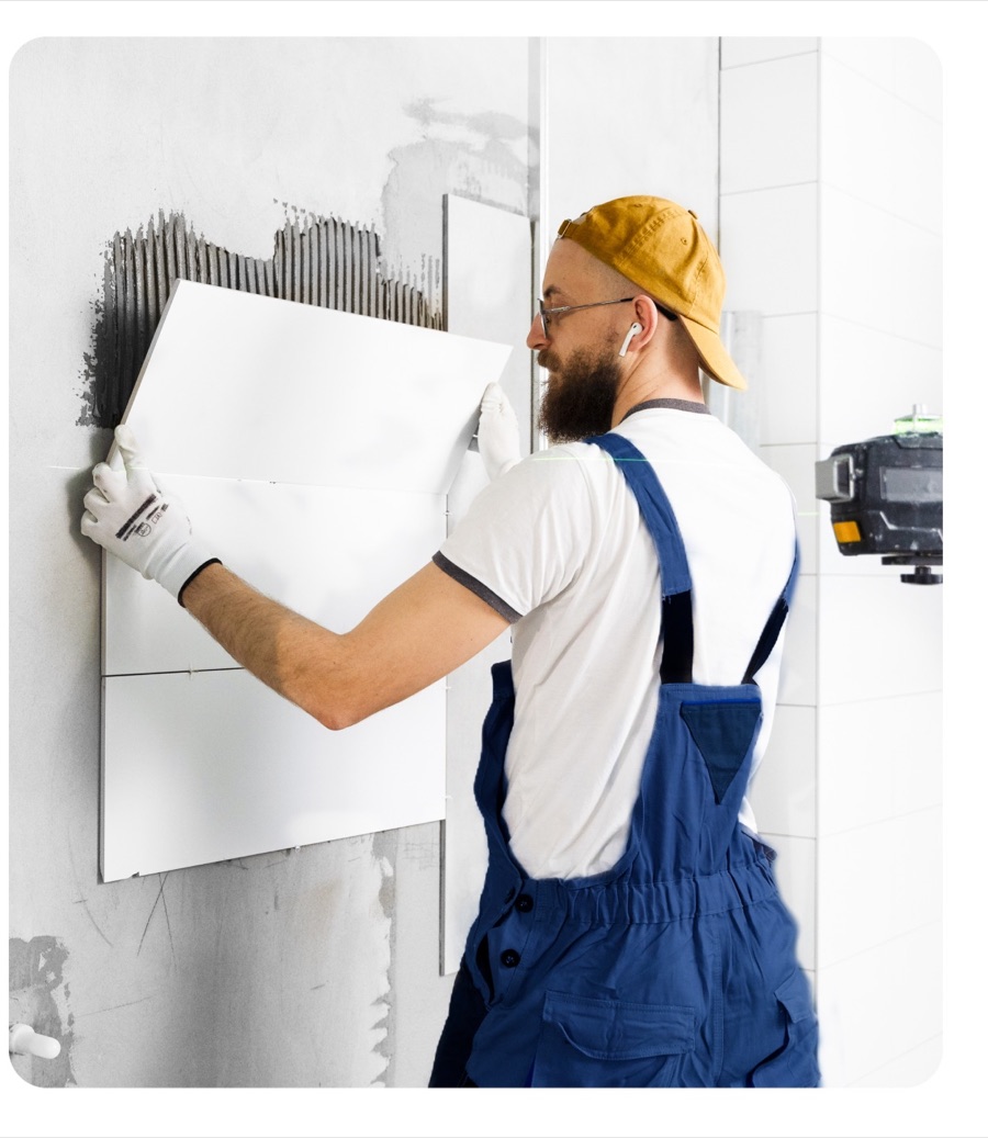 Handyman installing wall tile